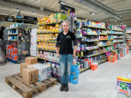 student worker clearing weekly delivery of goods at grocery store